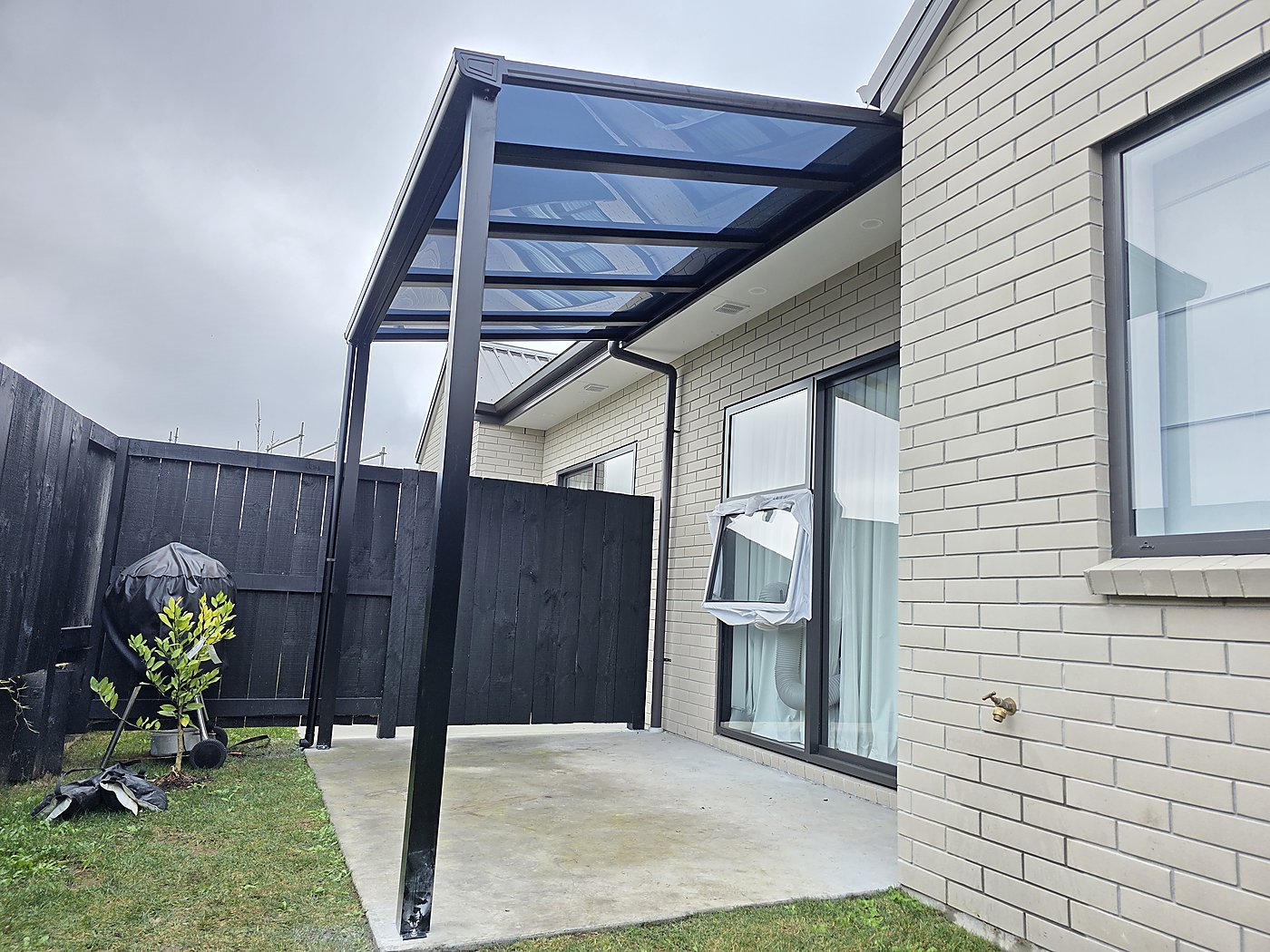 Black frame canopy over patio
