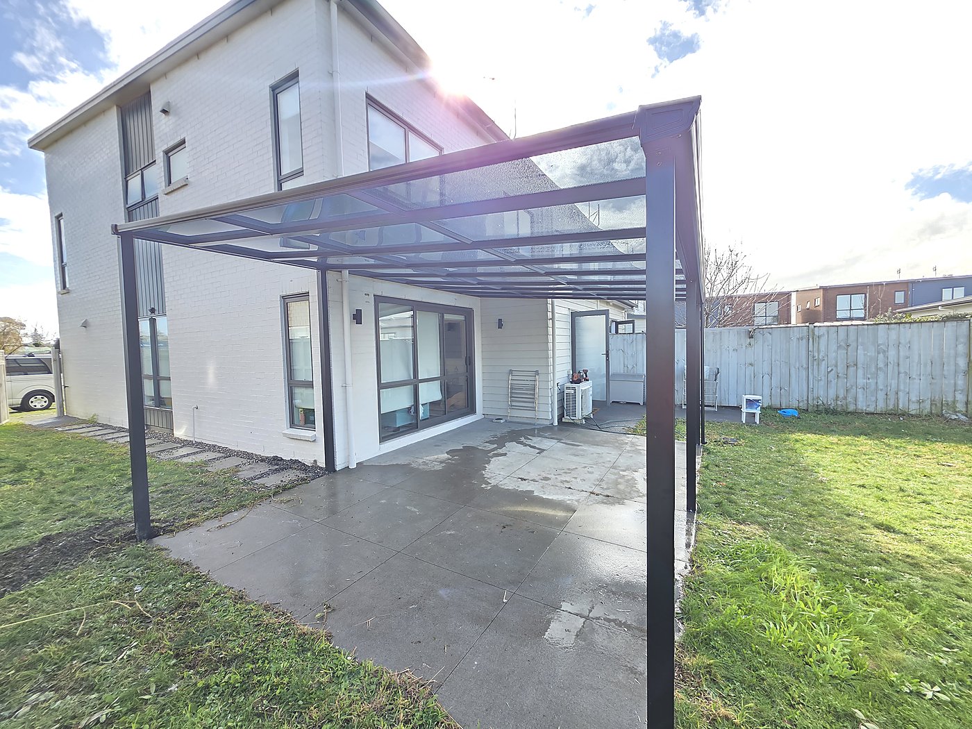 Glass canopy over narrow walkway
