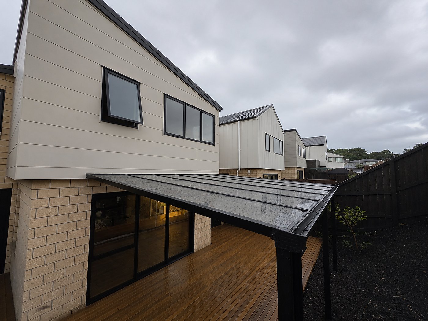 Flat roof pergola over timber deck